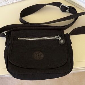 Kipling Small Black Crossbody Bag with Beige Interior.  Adjustable strap.